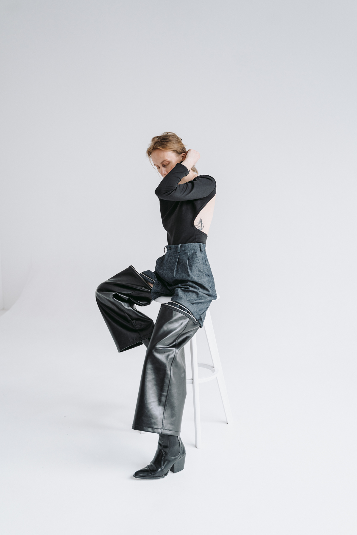 A Fashionable Woman Sitting on a Stool