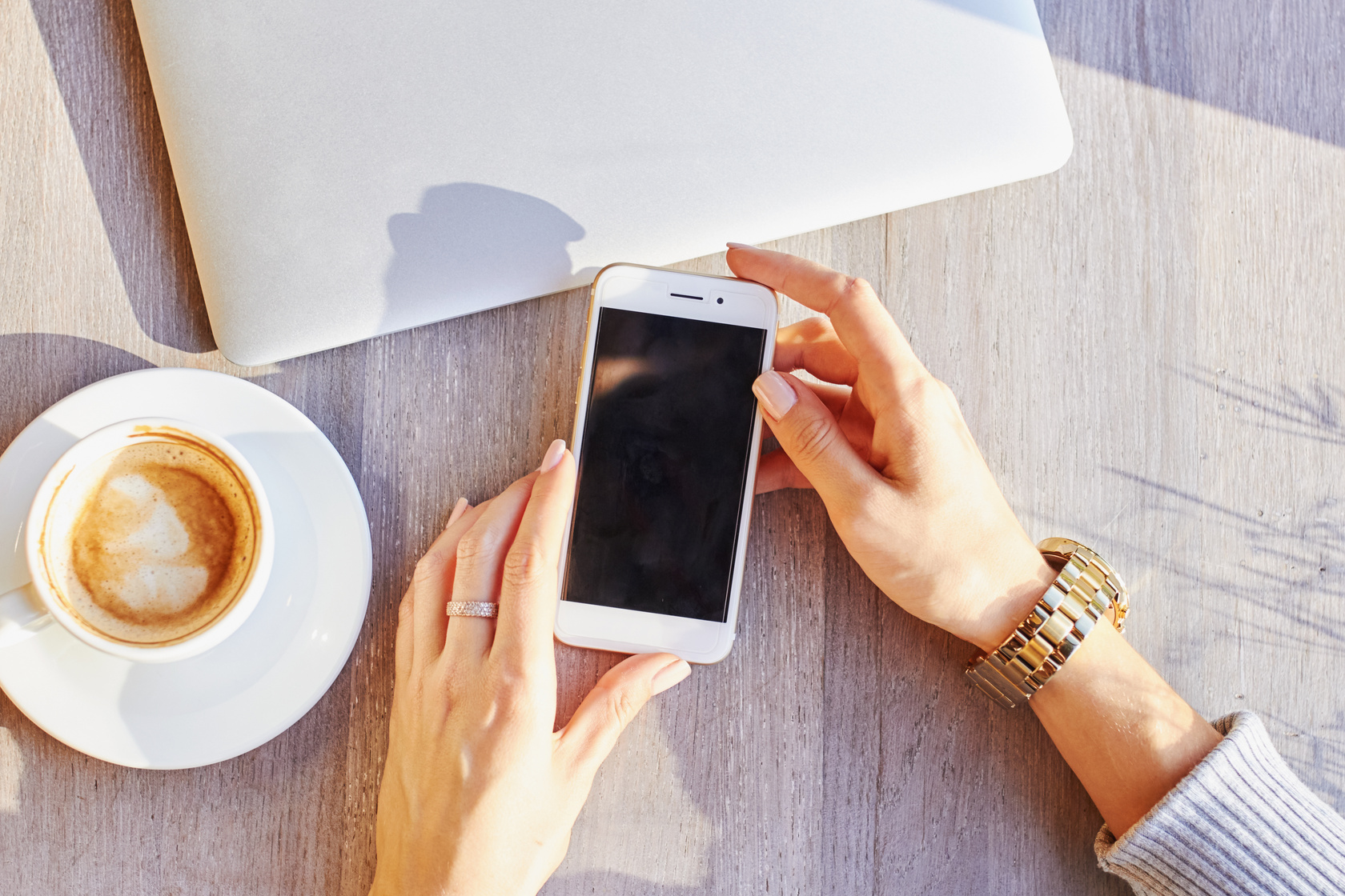 Woman Holding Smartphone on the Coffee Table