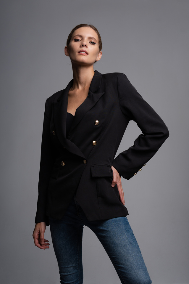 Woman in Black Blazer and Denim Pants
