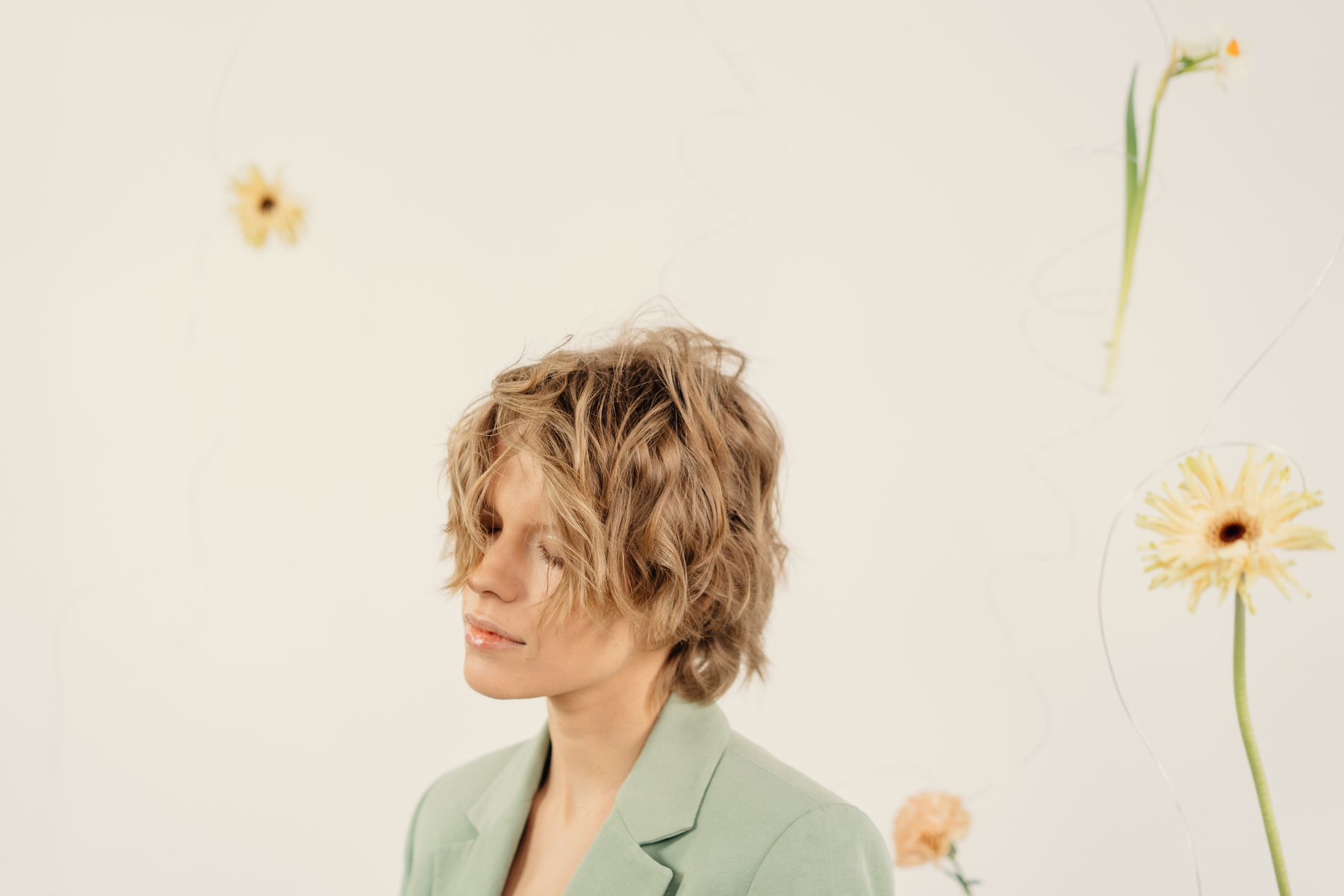 Woman in Green Blazer With Blonde Short Hair